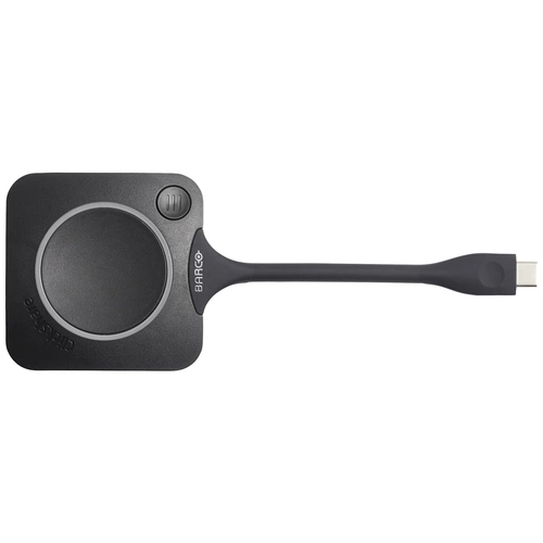 Ein kreisförmiges, schwarzes USB-Gerät mit 'Barco'-Logo; dient zur kabellosen Bildschirmübertragung.